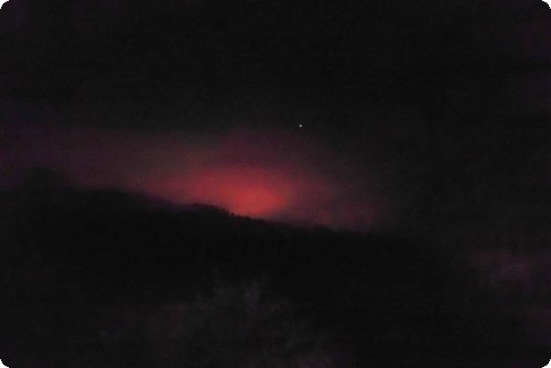 Gespenstisch: Der Himmel über den Bergen glüht und lodert